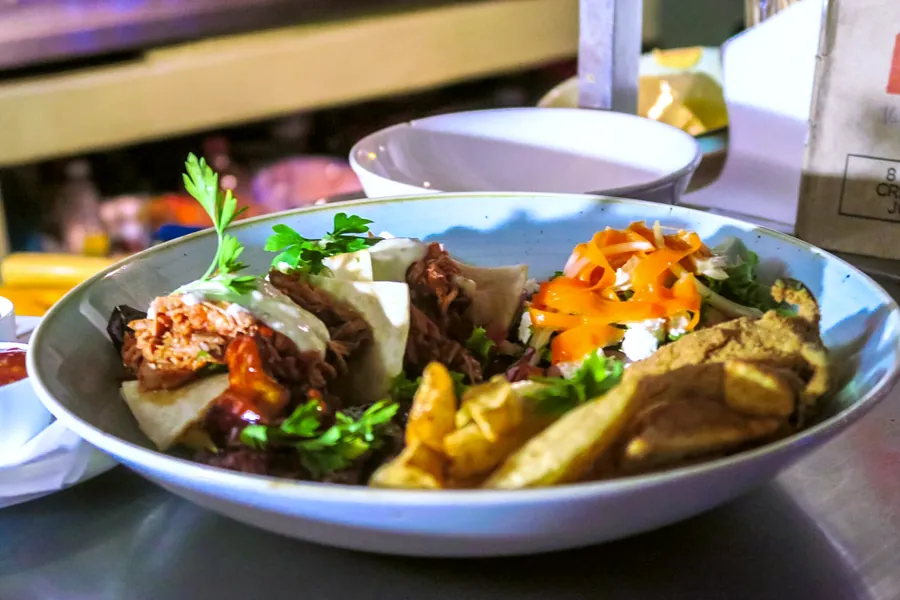 Pulled pork tacos with chips and a carrot salad